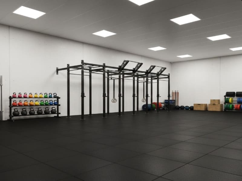 Split image showing a rugged garage gym with mats vs a sleek commercial box with rolls